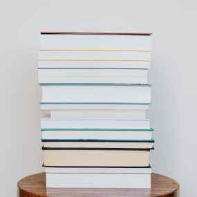 stack of books on wooden stool